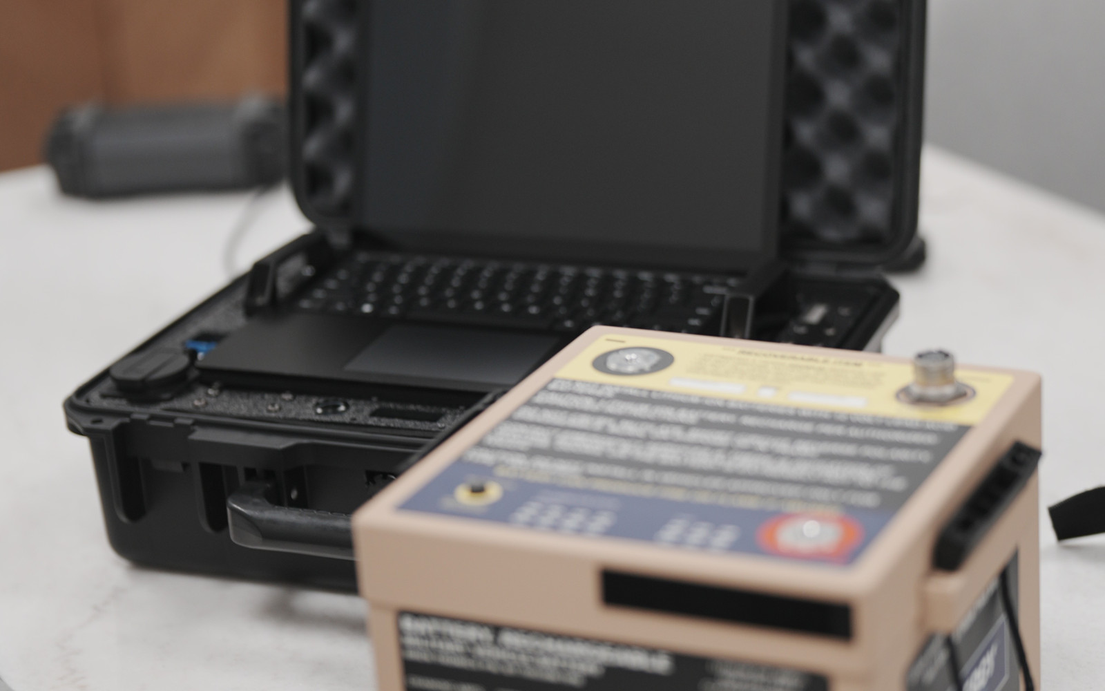 Rugged case with tan ruggedized AlloSense sensor unit for defense